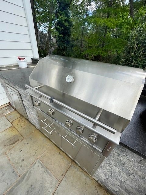 Built-in grill with white siding outdoor