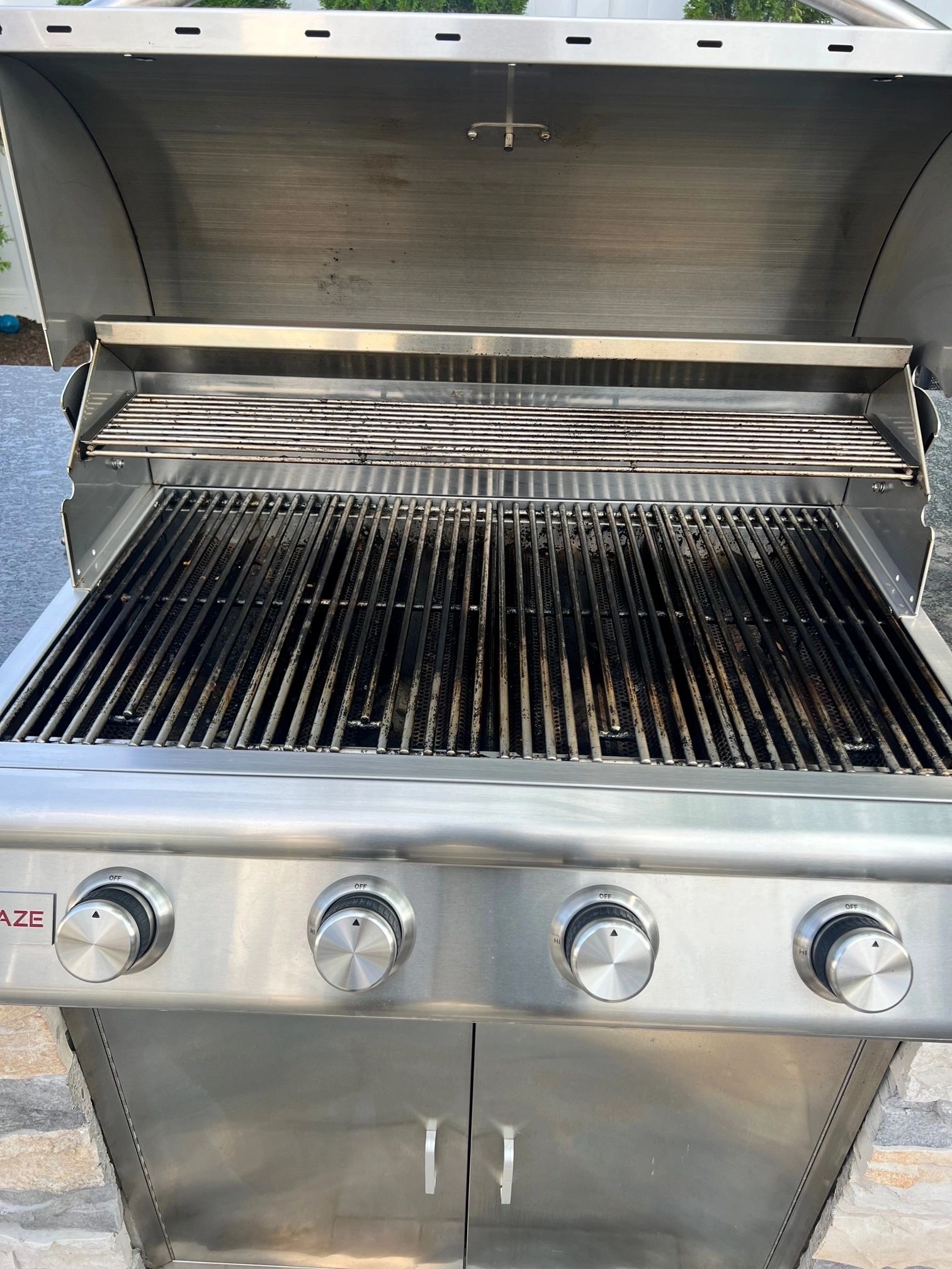 Open stainless steel grill showing clean grates