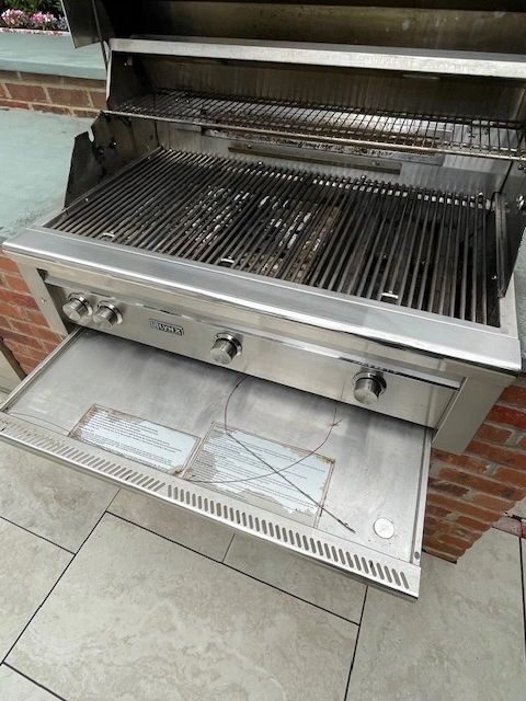 Built-in grill open lid cooking grates brick wall
